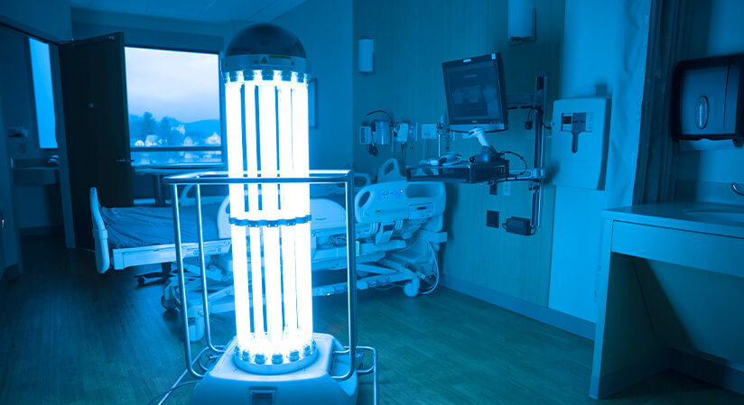 A large germicidal UV-C light disinfecting a hospital room.